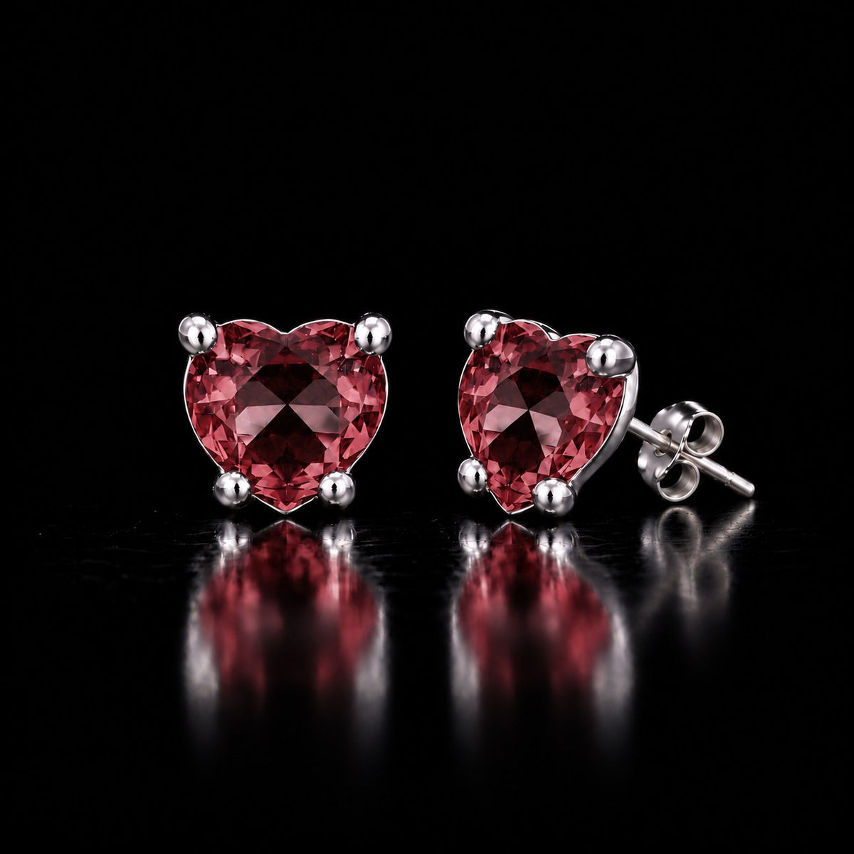 Pair of sterling silver VooDooStone heart-cut stud earrings, stones purplish-pink in daylight, shown with the post and butterfly back. Item 894788.