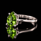 The same VooDooStone pear-cut solitaire ring in peridot green, angled side view. Item 894782.