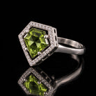 The same VooDooStone shield-cut halo ring in peridot green, angled view. Item 894784.