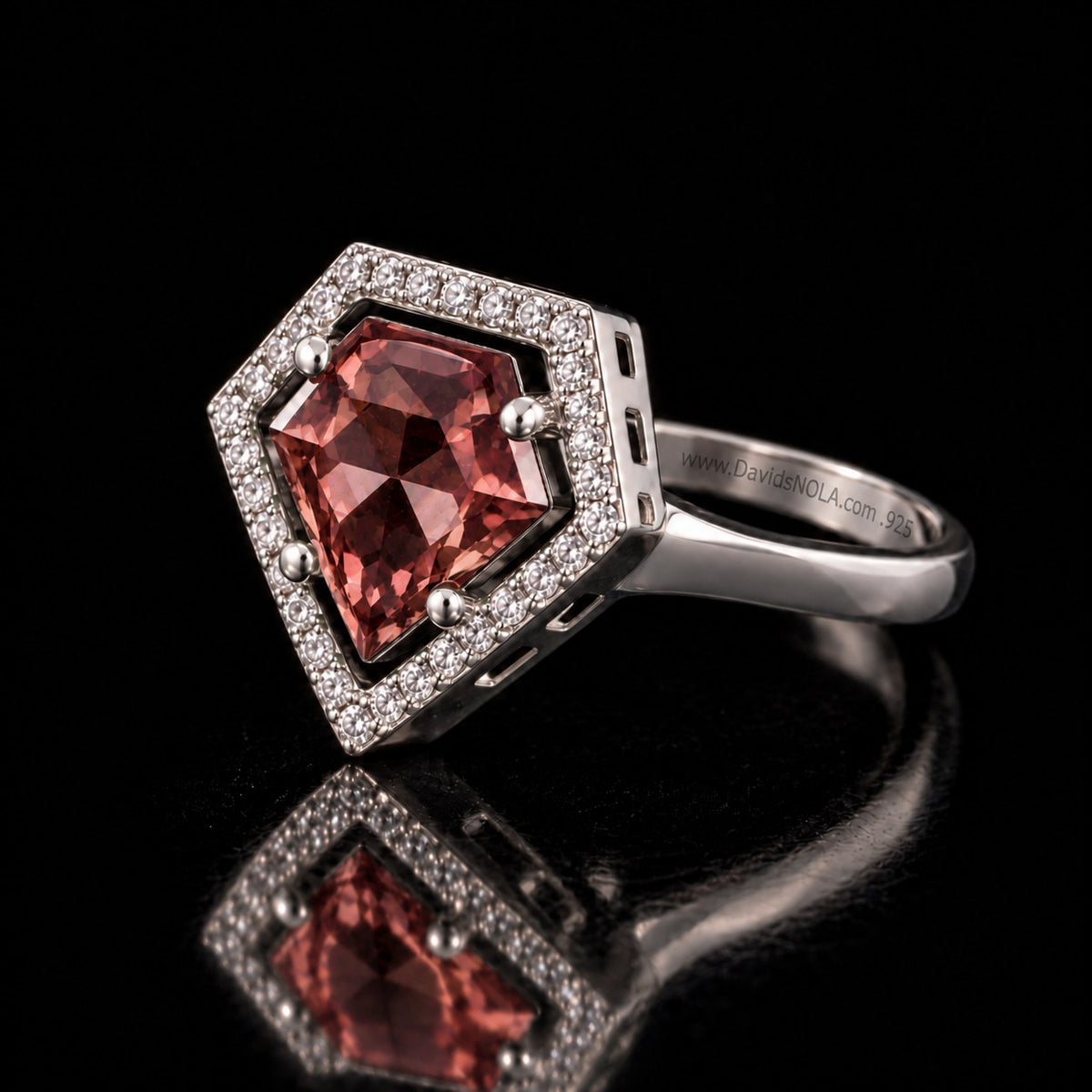 Sterling silver VooDooStone shield-cut halo ring in purplish-pink daylight colour, angled view showing the squared shoulders. Item 894784.