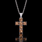 Sterling silver VooDooStone cross pendant with six round stones, purplish-pink in daylight, hanging from a chain shown for scale. Chain not included. Item 894790.